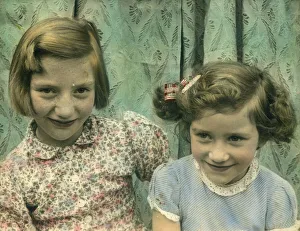 Delightful colour photograph of two little girls, possibly sisters, seated together Delightful colour photograph of two little girls, possibly sisters, seated together