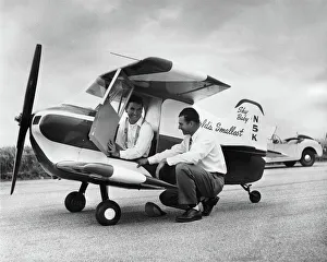 Designer Ray Stits Kneeling by and Test-Pilot Bob ( Robe? Designer Ray Stits Kneeling by and Test-Pilot Bob ( Robe?