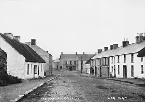 Prints of The Diamond, Bellaghy - a street scene with few people and thatched buildings. (Location: Northern Ireland: County Londonderry: Bellaghy). Date: circa early 1900s County Londonderry Prints: Early 20th Century Print of The Diamond, Bellaghy