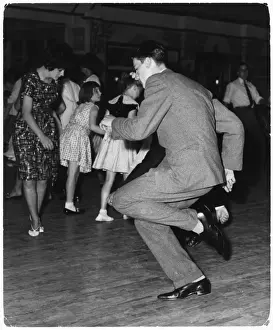 Doing the Twist Print: A Young Man in a Suit Twirls on the Dancefloor