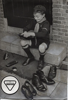Dutch cub scout polishing shoes, Netherlands Dutch cub scout polishing shoes, Netherlands