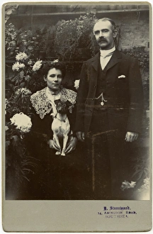 Edwardian couple with terrier dog in a garden Edwardian couple with terrier dog in a garden
