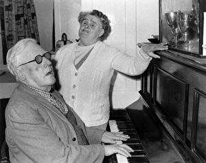 Elderly blind couple having a sing-song at the piano Elderly blind couple having a sing-song at the piano