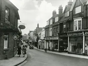 Prints of Winchester Road, Basingstoke, Hampshire, England, with its busy parade of individual shops. Date: early 1950s Winchester Prints: Early 1950s Basingstoke Winchester Road Print