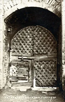 The fabulous gateway entrance to Chepstow Castle, Wales - lattice-work doors showing the repairs of age The fabulous gateway entrance to Chepstow Castle, Wales - lattice-work doors showing the repairs of age