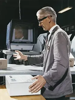 Historical Factory Images Prints: Factory worker operating control box