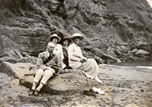Family group sitting on a beach at the seaside Family group sitting on a beach at the seaside