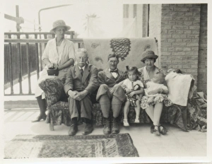 Family group on a sofa on a verandah Family group on a sofa on a verandah