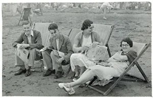 Family relaxing in deckchairs on the beach at Paignton Family relaxing in deckchairs on the beach at Paignton