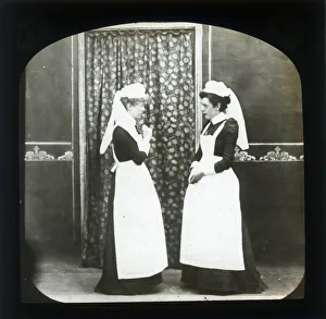 Two female domestic servants in discussion Two female domestic servants in discussion