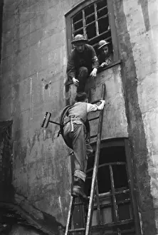 Print of a firefighter using a stirrup pump in post-air raid London
