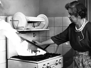 Fire Safety in the Kitchen Print - Woman Covers Burning Pan