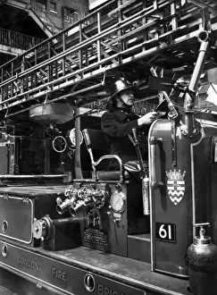London Firefighting Service Prints: Firefighter at the wheel of a fire engine