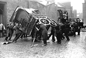 Firefighters attempt to right a fallen cart, WW2 Firefighters attempt to right a fallen cart, WW2