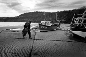 Fisherman walks up the beach - New Quay, Wales Fisherman walks up the beach - New Quay, Wales