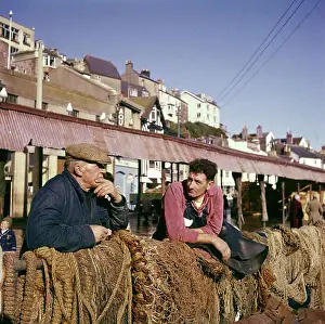 Coastal Towns In England Prints: Two fishermen in Brixham Harbour, Devon