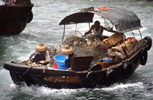 A fishing boat returns to Aberdeen Harbour, SW Hong Kong A fishing boat returns to Aberdeen Harbour, SW Hong Kong