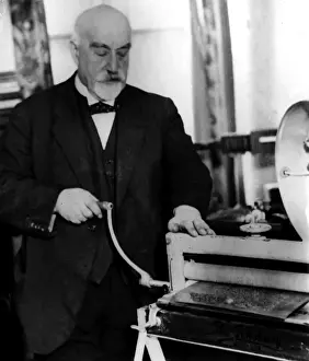Prints of DR. FREDERICK WILLIAM ALEXANDER, OBE. Depicted making anagrams and crossword puzzles in Braille for the blind, with the aid of an ordinary washing mangle William Alexander Prints: Dr. Frederick William Alexander Making Braille Puzzles Print