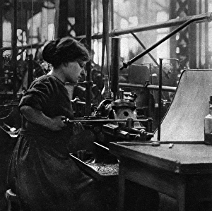 French woman in a munitions factory, making parts for arti French woman in a munitions factory, making parts for arti