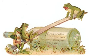 Three frogs seesawing on a cutout Christmas card Three frogs seesawing on a cutout Christmas card