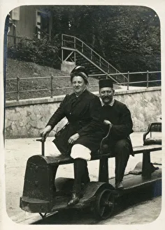 A German couple on a fun miniature railway ride, possibly at the seaside A German couple on a fun miniature railway ride, possibly at the seaside