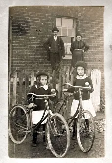 Two girls with their new bicycles and proud parents Two girls with their new bicycles and proud parents
