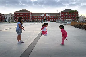 Three girls with skipping rope - plaza, Es Castell, Menorca Three girls with skipping rope - plaza, Es Castell, Menorca