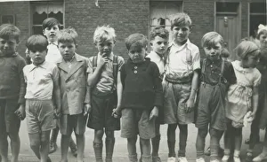A group of children lined up for a photograph in a terraced street. Date: 1930s A group of children lined up for a photograph in a terraced street. Date: 1930s