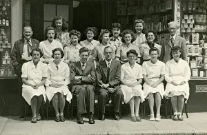 Group photo, staff outside a grocery shop Group photo, staff outside a grocery shop