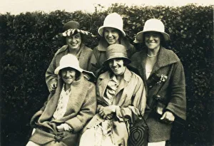 A group of five women posing for a photograph in the 1920s, all in hats A group of five women posing for a photograph in the 1920s, all in hats