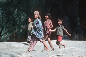Four happy Kashmir children run along banks of River Jhelum Four happy Kashmir children run along banks of River Jhelum