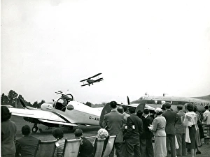 A de Havilland Moth flies past the de Havilland Dove, G-? A de Havilland Moth flies past the de Havilland Dove, G-?