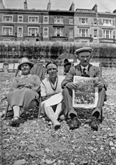 Holidaymakers on the beach at Hastings, Sussex Holidaymakers on the beach at Hastings, Sussex