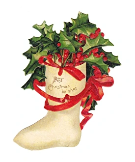 Holly and red ribbon on a cutout Christmas card Holly and red ribbon on a cutout Christmas card