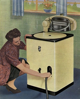 Housewife with her new Ritemp electric washing machine Housewife with her new Ritemp electric washing machine
