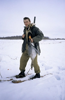 Hunter with shot wild goose (Bean goose) Hunter with shot wild goose (Bean goose)
