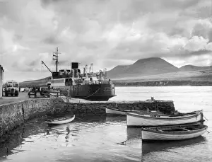 Prints of Port Askaig, a small village on the Sound, Isle of Islay Argyllshire, Scotland. Here terminates the ferry which crosses the Sound to Feolin on Jura. The Paps of Jura beyond Related Prints: Islay Ferry Port Askaig Print