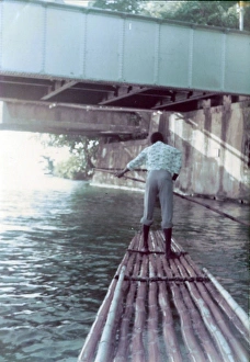 Jamaican man rafting under the bridge down the Rio Grand, Ja Jamaican man rafting under the bridge down the Rio Grand, Ja