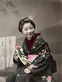 Japan - young woman in ornate kimono, smiling Japan - young woman in ornate kimono, smiling