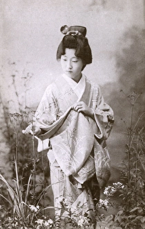 Japanese Geisha examining some plants Japanese Geisha examining some plants