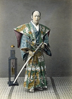 Japense samurai (actor) with a clock, Japan, circa 1880s Japense samurai (actor) with a clock, Japan, circa 1880s