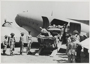 Jeep being loaded into the fuselage of a Dakota transport pl Jeep being loaded into the fuselage of a Dakota transport pl