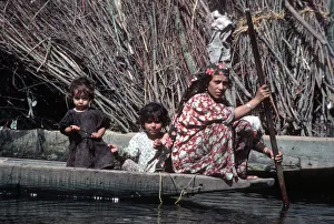 Kashmir, River Jhelum - woman paddles a wooden boat Kashmir, River Jhelum - woman paddles a wooden boat