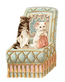 Two kittens on a chair on a cutout Christmas card Two kittens on a chair on a cutout Christmas card