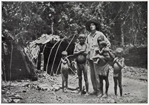 Lady Broughton, travelling in southern Africa, poses with a family of pygmies Lady Broughton, travelling in southern Africa, poses with a family of pygmies