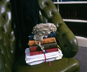 Lawyers books, brief and wig in a leather chair Lawyers books, brief and wig in a leather chair