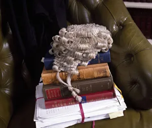 Lawyer's books, brief and wig in a leather chair Lawyer's books, brief and wig in a leather chair