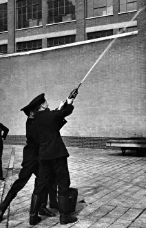 LFB Firefighters Prints: LFB firefighters using a hand squirt