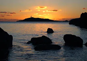 The lighthouse on Little Ross Island flashes at sunset The lighthouse on Little Ross Island flashes at sunset