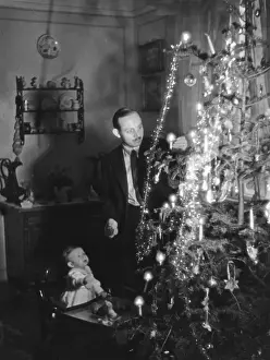 Historical Christmas Decorations Prints: Lighting Candles on Tree